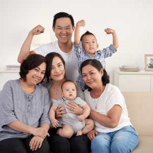 asian-extended-family-with-baby-toddler-posing-together-around-couch-home